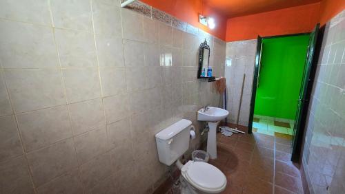 a bathroom with a white toilet and a sink at El Viejo in Río Mayo