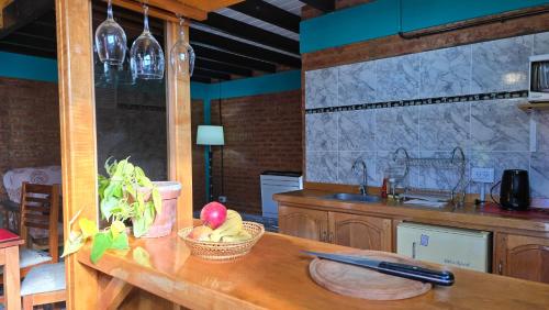 a kitchen with a table with a bowl of fruit on it at El Viejo in Río Mayo