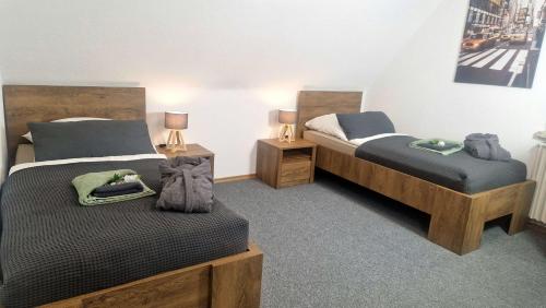 a bedroom with two beds and two night stands at Ferienwohnung LandLicht mit Terrasse in ruhiger Lage in Sulingen