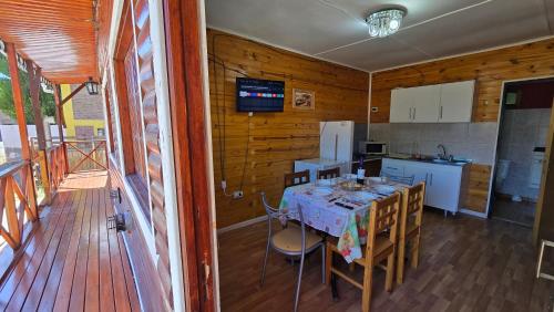 a kitchen with a table and chairs in a room at El Viejo in Río Mayo