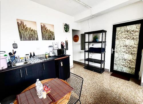a kitchen with a sink and a table in a room at Apto tipo Estudio zona 1 in Guatemala