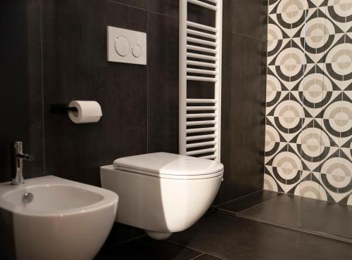 a bathroom with a white toilet and a sink at Paponena Holidays in Riva del Garda