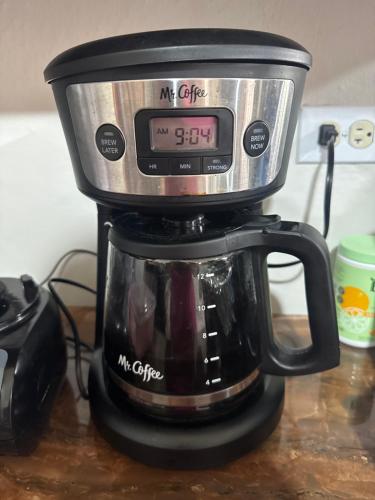a coffee maker with a clock on top of it at Esmes vacation home in La Milagrosa
