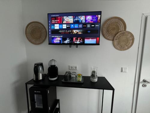 a flat screen tv hanging on a wall at ART House /15 Min. Düsseldorf Messe,Airport & City in Meerbusch