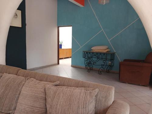 a living room with a couch and a table at Casa con alberca y jardin en parres jiutepex in Jiutepec