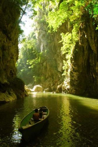 a group of people in a boat in the water at Tortugal Boutique River Lodge in Rio Dulce