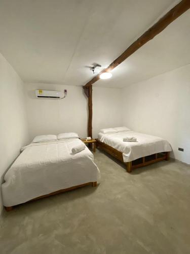 a room with two beds in a room at Cabañas W Beach in Cartagena de Indias