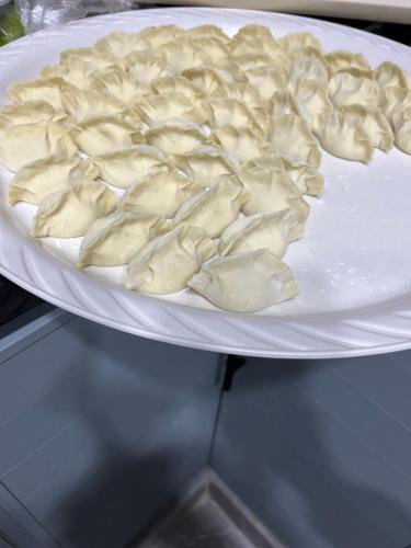a plate of dumplings on a white plate at 龙门客栈 in Amman