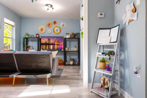 a living room with a couch and a shelf at Cultural Heritage Award winning home - Ideal for Holiday Stays & Lake Walks in Austin