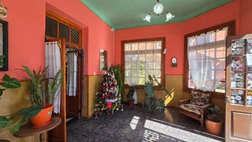 a living room with a christmas tree in the corner at El Viejo in Río Mayo