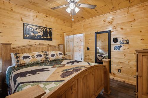 a bedroom with a bed in a log cabin at On Blackbeary Hill A cozy 3 BR cabin perfect for a getaway in an enchanting forest setting in Pigeon Forge