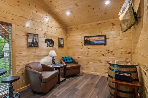 a log cabin office with a chair and a desk at On Blackbeary Hill A cozy 3 BR cabin perfect for a getaway in an enchanting forest setting in Pigeon Forge