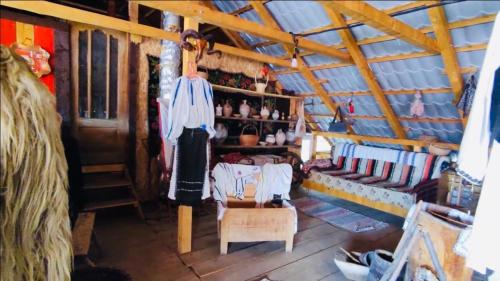 an attic room with a couch and a chair at Casa Emilia in Baia de Fier
