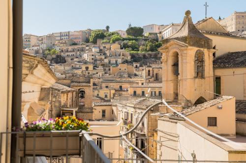 a view of the city from the balcony of a building at La Dolce Vista in Modica