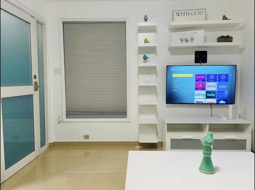 a living room with a tv and a window at Hollywood Apartments - H in Yabucoa