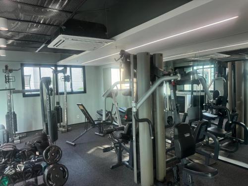 a gym with lots of treadmills and machines at Suites in B Tree Av Paulista in Sao Paulo
