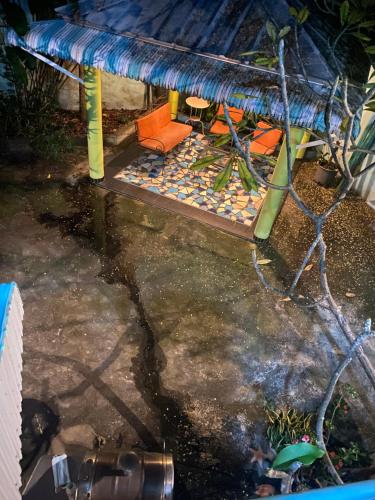 a patio with a bench and a table and chairs at Casa Azul - Apartment in San Felipe de Puerto Plata