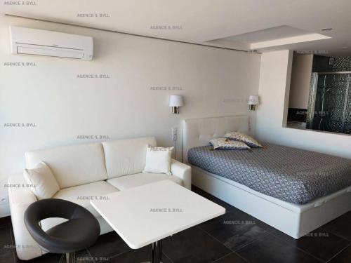 une chambre avec un lit, un canapé et une chaise dans l'établissement Résidence Héliopolis Bâtiment K - Studio 2 pers. Héliopolis K MAE-4604, au Cap d'Agde