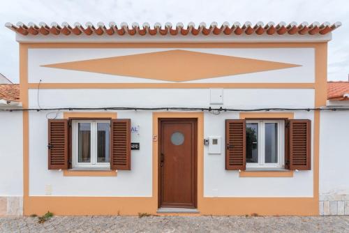 a house with two windows and a door at Casa Arte 5 in Aljezur
