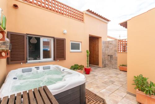 a hot tub in a patio of a house at Casa Arte 5 in Aljezur