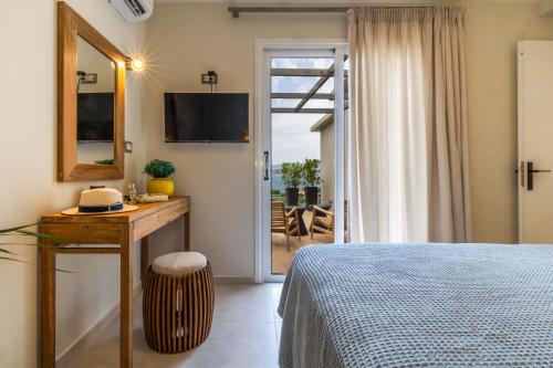 a bedroom with a bed and a door to a patio at THALASSA VIEW RESIDENCE in Argostoli