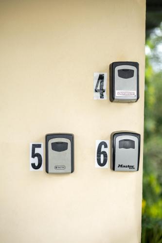 a wall with clocks on the side of a house at D'Rosas Apartments in Santiago