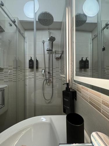 a bathroom with a shower and a bath tub at B&B Terrace09 in Castellana Grotte