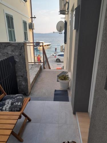 a balcony with a bench and a view of the ocean at Anita in Zaostrog