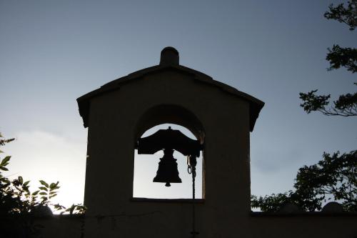 a bell in a tower with a window at Podere Dell'Arco Country Charme in Viterbo