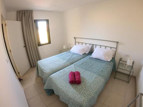 Giường trong phòng chung tại Drago 2 Atlantic Garden apartment