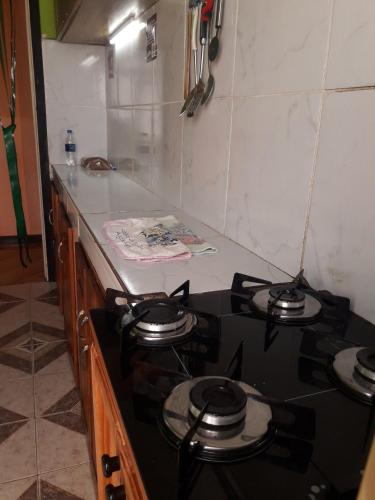 a stove top in a kitchen with a counter top at Damaris Hostel in Puerto Iguazú