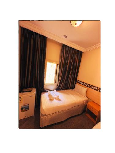 Postel nebo postele na pokoji v ubytování فندق كرمك مكةhotelkaramak