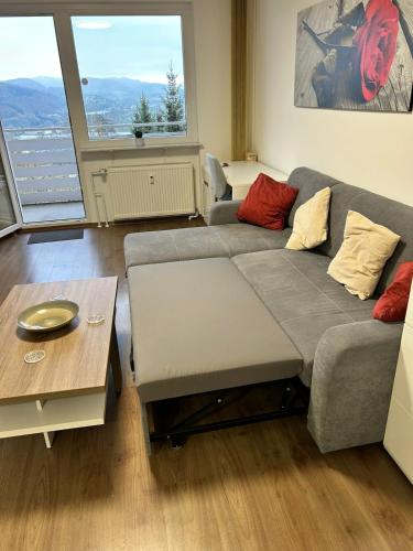 a living room with a couch and a table at Life Modern, Smart Appartment Balkon in Plettenberg