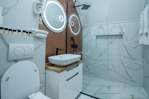 a bathroom with a toilet and a sink and a shower at JEZERSKA RESIDENCE Palić in Palić