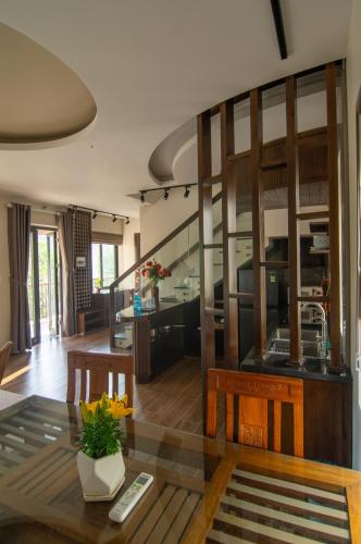 a kitchen and living room with a table and chairs at Sealight Villa and House Phu Quoc in Phu Quoc