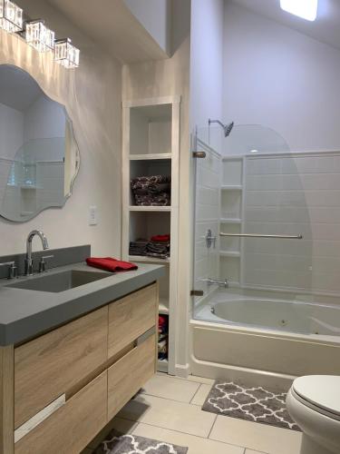 a bathroom with a sink and a tub and a toilet at Lazy Lake Life Awaits! in Monticello