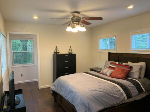 a bedroom with a bed with a ceiling fan at Lazy Lake Life Awaits! in Monticello