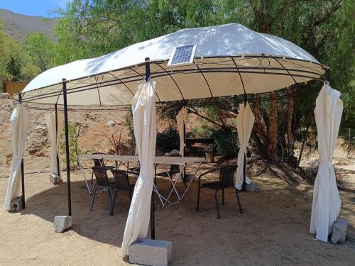 a gazebo with a table and chairs under it at Casa Alma in Vicuña