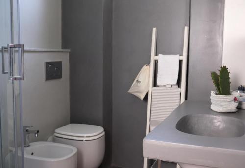 a bathroom with a toilet and a sink at My Place Your Place in Corniglia