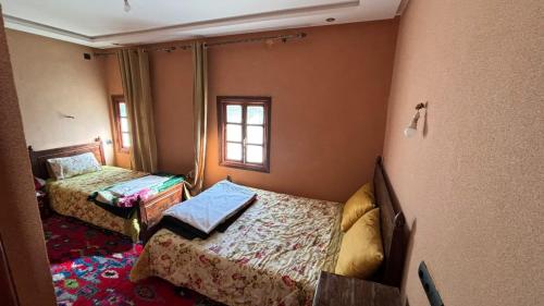 Una cama o camas en una habitación de Auberge Mzik