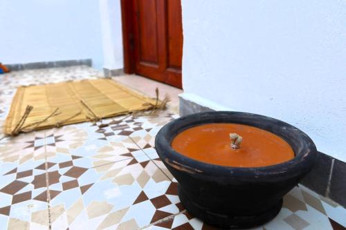a bowl of soup sitting on a tiled floor at Little Beach House Sidi Kaouki in Sidi Kaouki