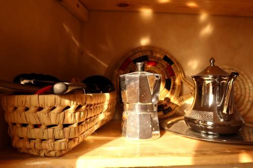 a tea kettle and a basket on a table at Little Beach House Sidi Kaouki in Sidi Kaouki
