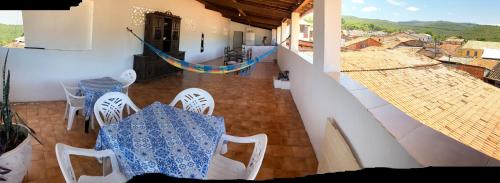 a room with a table and chairs and a view at Casa my House in Lençóis