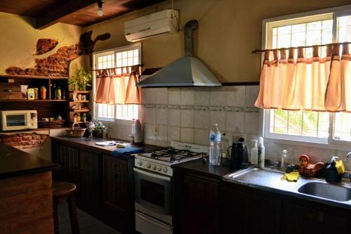 a kitchen with a sink and a stove top oven at El Descanso in Funes
