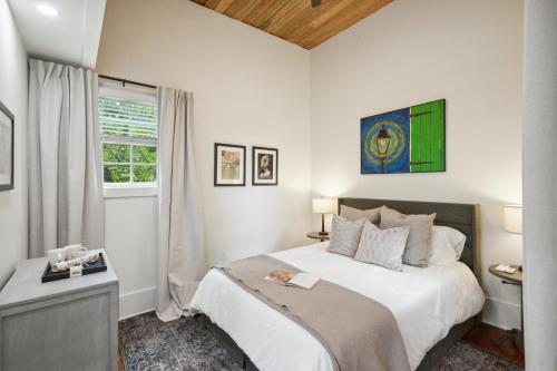 a white bedroom with a bed and a window at Saint Claude Stunner in New Orleans