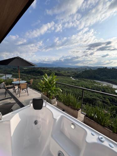 a white bath tub sitting on top of a balcony at cabaña mulata in La Tebaida