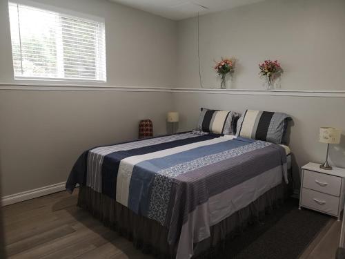 a bedroom with a bed and a window with flowers at Cozy in London
