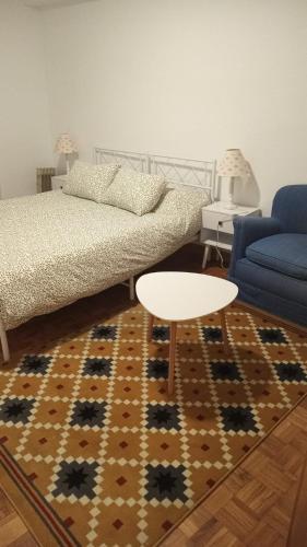 a living room with a couch and a table at La consulta de Paloma, Plaza encanto historico in Riaza
