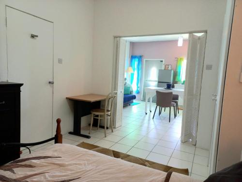 a bedroom with a bed and a table and a desk at Nested View- Spacious & quiet Apt 2 Nested Point Old Westerhall in Belle Plain
