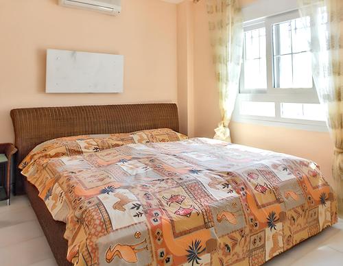 a bedroom with a bed with a quilt on it at Elegant Villa in Nuevo Portil with Shared Pool in El Portil